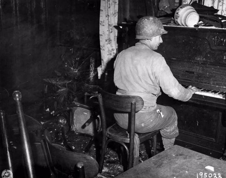 Pfc. R. Larock playing piano, killed two days later